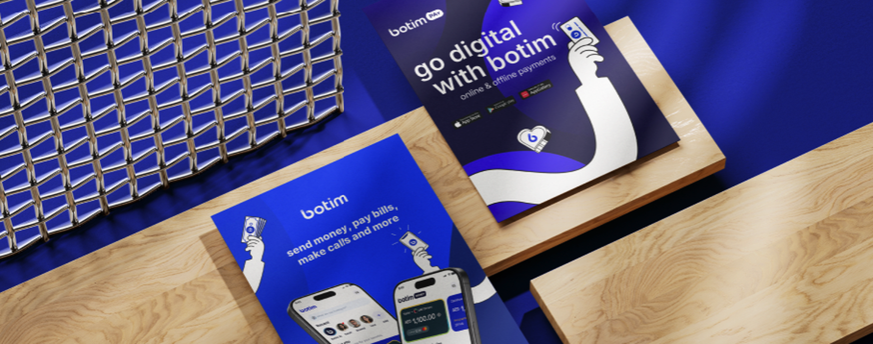 Two blue Botim marketing brochures on a table with the headline 'go digital with Botim' and app screens.